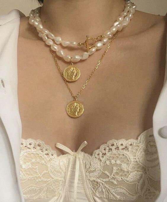 Light Academia style clothes and accessories inside a mysterious box, blending vintage charm with modern elegance