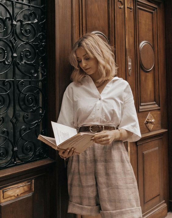 Light Academia style clothes and accessories inside a mysterious box, blending vintage charm with modern elegance