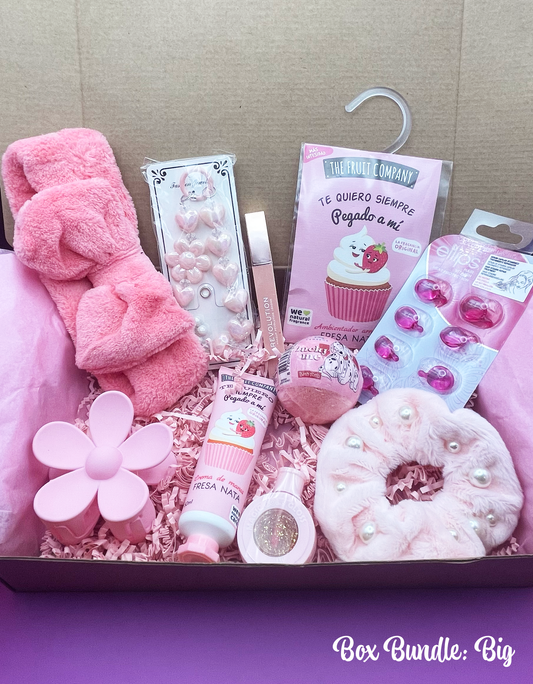 A variety of pink-themed items including makeup, beauty care products, and fashion accessories arranged neatly inside a pink box with a 'Box Bundle: Big' label.