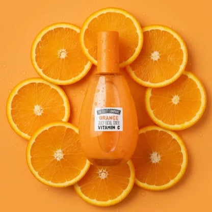 Orange juice bottle surrounded by sliced oranges on an orange background
