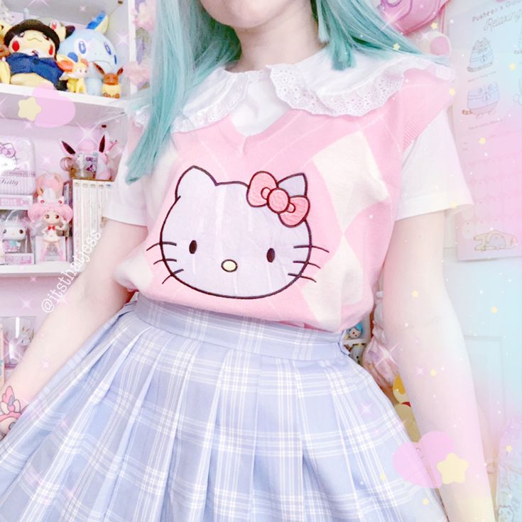 Person wearing a Hello Kitty shirt with a pastel pink and white design, standing in a room with plush toys.