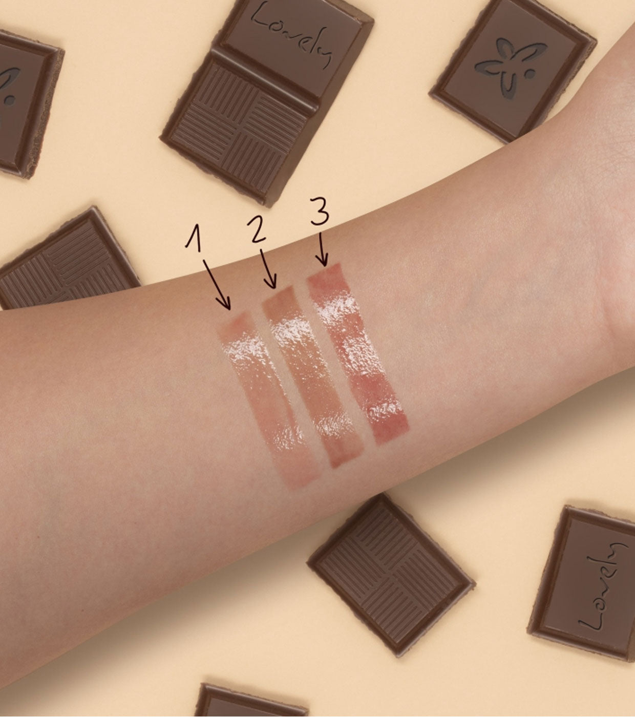 Lipstick swatches on a person's arm with chocolate bars in the background
