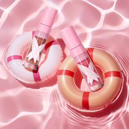 Two perfume bottles with pink and red lifebuoys on a pink water background