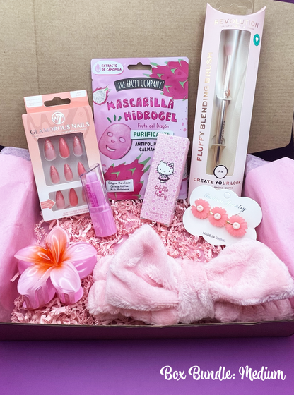 A variety of pink-themed items including makeup, beauty care products, and fashion accessories arranged neatly inside a pink box with a 'Box Bundle: Big' label.