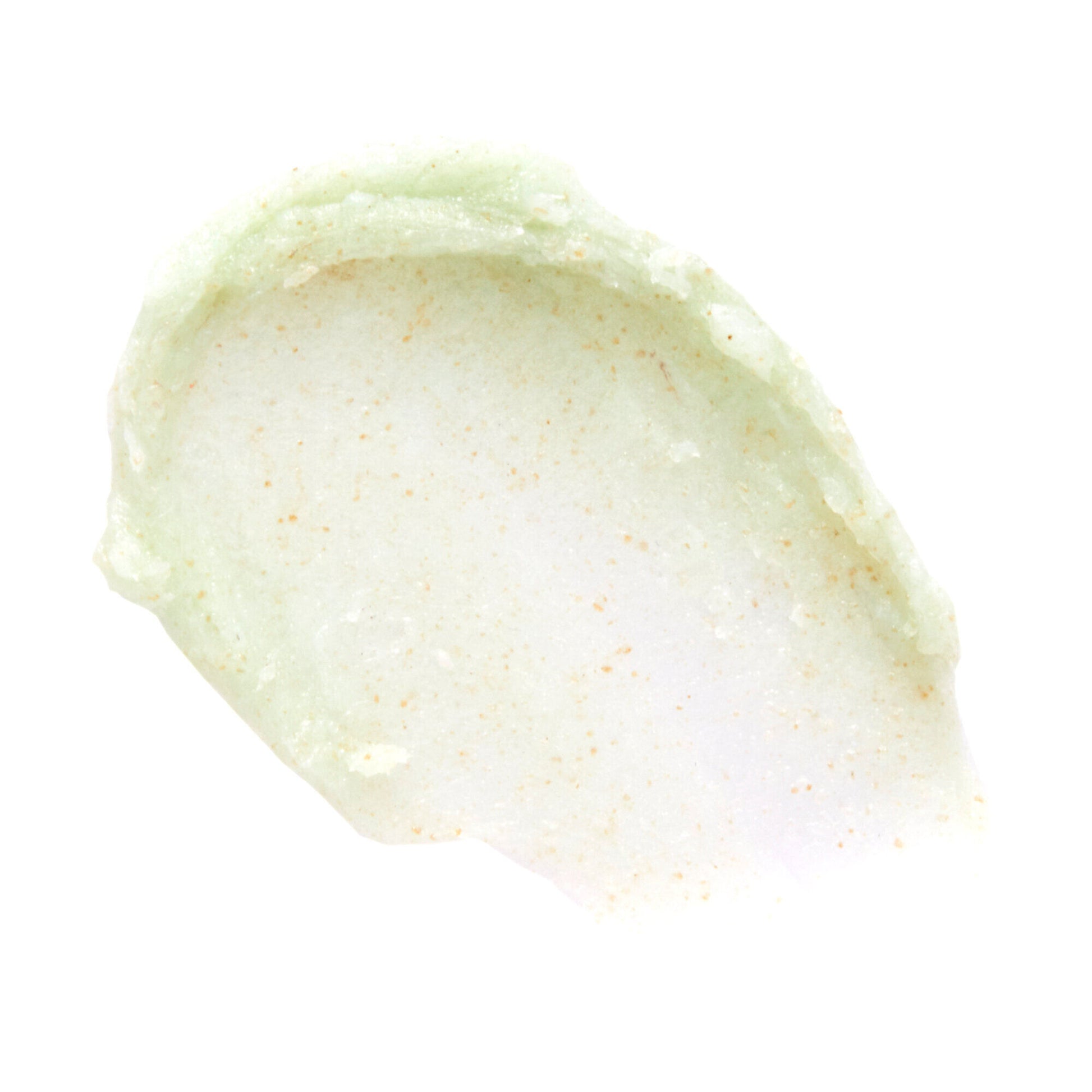 Close-up of a light green cream or paste on a white background