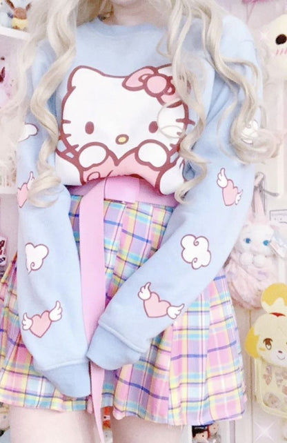 Person wearing a pastel-colored outfit with Hello Kitty design, surrounded by plush toys.